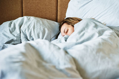 Woman sleeping in the bed at morning