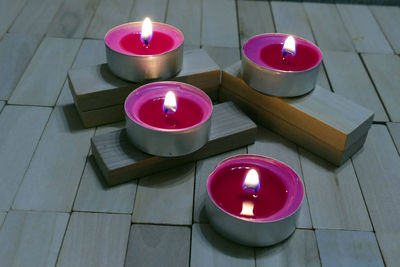 High angle view of lit candles on table