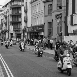 People riding motorcycle on city street