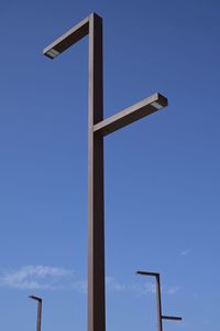 Low angle view of cross against clear blue sky