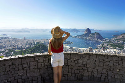 Rear view of woman looking at cityscape in rio de janeiro, brazil