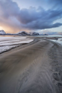 Scenic view of beach against sky during winter