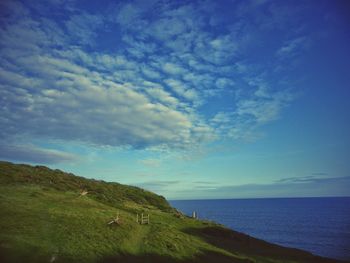 Scenic view of sea against cloudy sky