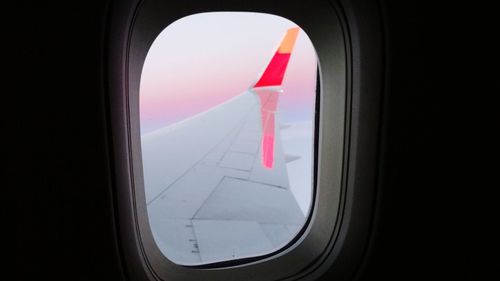 Close-up of airplane wing seen through window