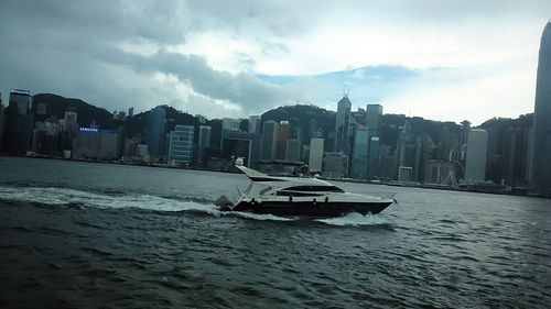 Scenic view of sea and city against sky