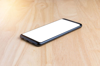 High angle view of smart phone on table