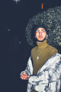 Portrait of young man standing in snow