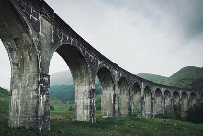 Low angle view of arch bridge against sky