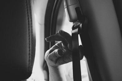 Cropped image of person touching seat belt