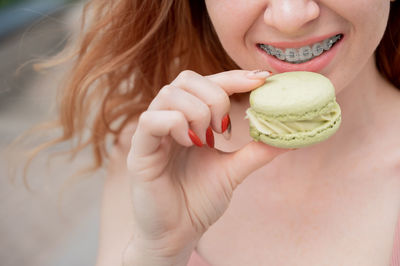 Midsection of woman holding apple