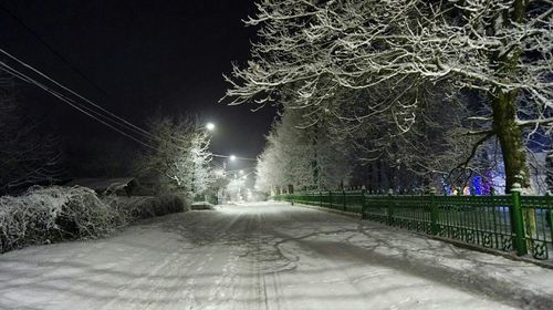 Snow covered road at night