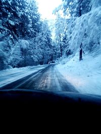 Road passing through snow covered mountain