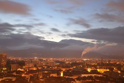 High angle view of city against cloudy sky during sunrise