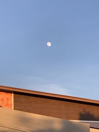 Low angle view of moon against blue sky