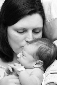 Close-up of mother kissing baby