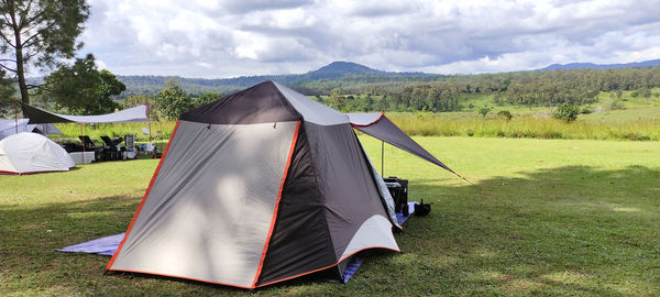 Tent on field against sky