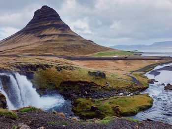 Scenic view of waterfall against sky