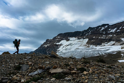 Hiking mountain ridge near glacier in yoho national park