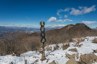 Scenic view of snow covered field against sky