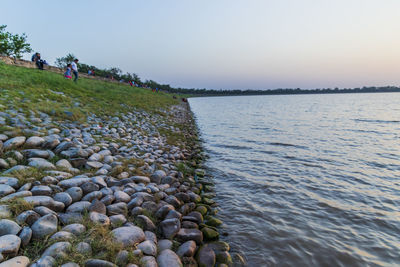 Scenic view of rocks in lake against sky