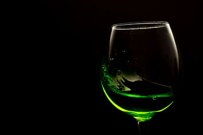 Close-up of beer glass against black background