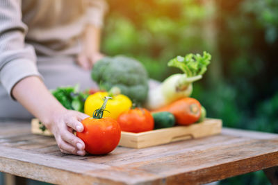 Midsection of man with fruits on table