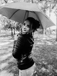 Portrait of young woman standing on wet floor