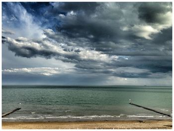 Scenic view of sea against cloudy sky