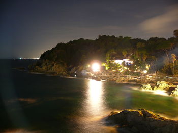 Scenic view of sea and mountains at night