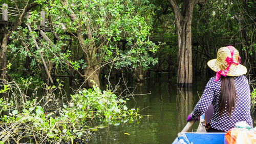 Woman sitting by lake