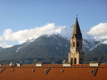 Low angle view of building and mountains against sky