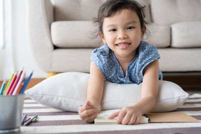 Portrait of smiling boy sitting on sofa at home