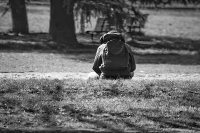 Rear view of woman walking on grass