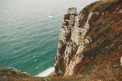 High angle view of sea by cliff
