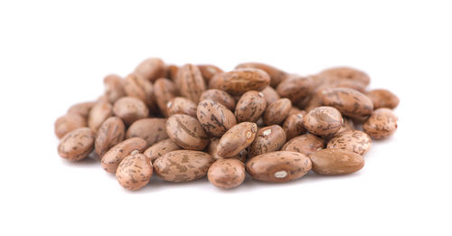 Close-up of roasted coffee over white background