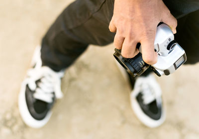 Low section of man holding hands