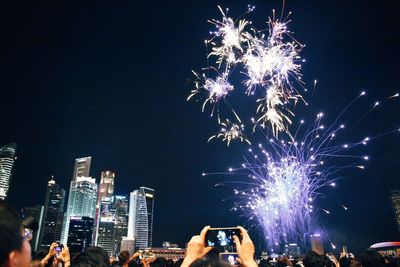 Low angle view of firework display against sky at night