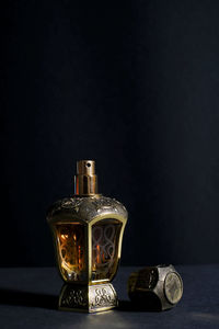 Close-up of wine glass on table against black background