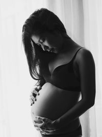 Midsection of woman standing at home