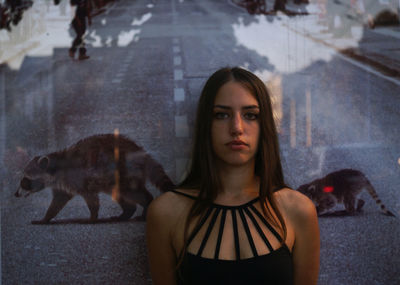 Multiple image of beautiful young woman against raccoons on road