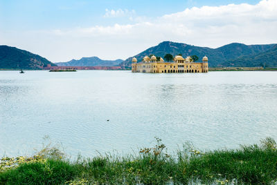 Scenic view of lake against cloudy sky