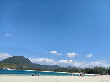 Scenic view of beach against blue sky