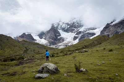 Rear view of man standing on rock