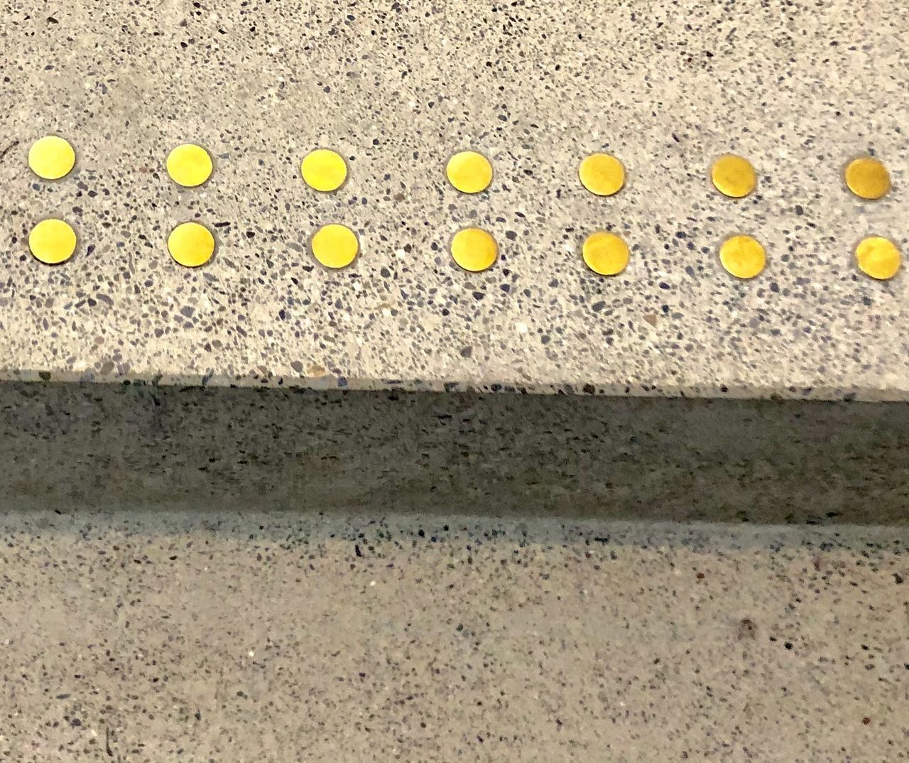 HIGH ANGLE VIEW OF YELLOW PETALS ON SAND