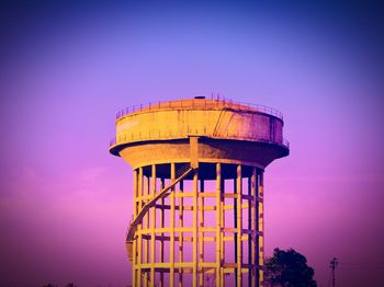 Low angle view of water tower against blue sky