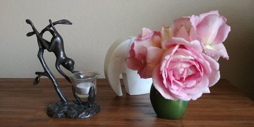 Close-up of pink roses in vase on table