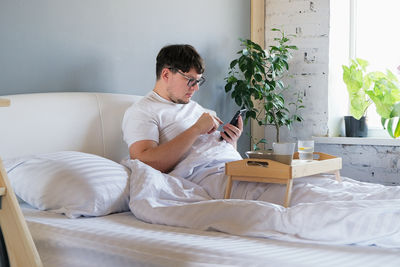 Young woman using digital tablet at home