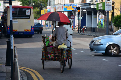 Rear view of man sitting on road