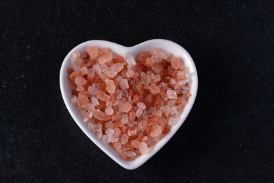 High angle view of heart shape on table against black background