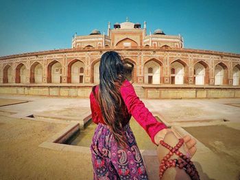 Woman standing outside temple